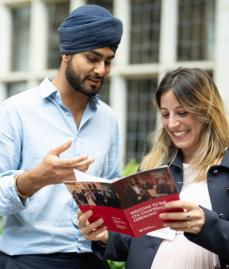man talking, whilst woman looking at pamphlet