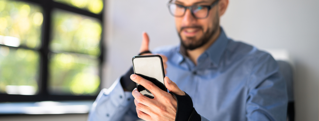 man with wristband on phone